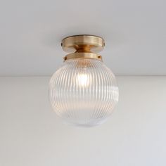 a close up of a light fixture on a ceiling with a white wall in the background