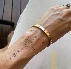 a woman's arm with a tattoo on it that reads, sun and stars