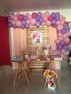 there is a table with balloons and decorations on it, along with a sign that says paw patrol