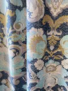 closeup of blue and gold fabric with white flowers