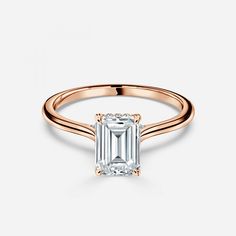 a rose gold ring with an emerald cut diamond