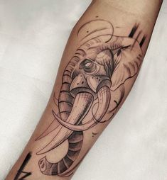 an elephant tattoo on the left arm and leg is shown in black and grey ink