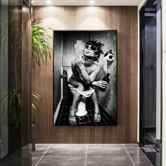 a black and white photo of a naked woman sitting on a toilet in a bathroom