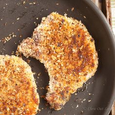 two pieces of meat sitting in a frying pan