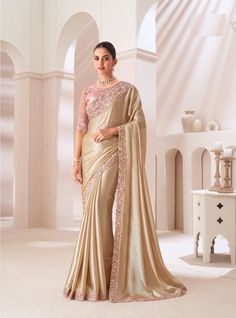 This luxurious designer saree is the epitome of elegance for wedding wear and grand parties. Crafted from rich satin gold chiffon, it drapes beautifully, offering a regal look with a soft, lustrous sheen. With a generous length of 6.5 meters, this saree flows effortlessly, perfect for creating timeless silhouettes. The satin gold hue brings a subtle opulence, making it ideal for formal occasions and festive events. Complementing this stunning saree is a blouse made from satin silk net, intricately embroidered with delicate threadwork and shimmering sequins. The embroidery adds a layer of glamour and sophistication, ensuring you stand out at any gathering. This ensemble blends modern luxury with traditional craftsmanship, making it a must-have for your wardrobe. Whether it's a wedding recep Party Saree, Golden Saree, Bridesmaid Saree, Party Sarees, Simple Sarees, Party Wear Saree, Satin Saree, Ethnic Looks, Chiffon Saree