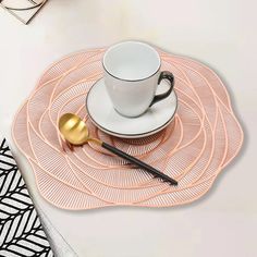 a place mat with a cup and spoon on it