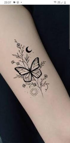 a small butterfly tattoo on the arm