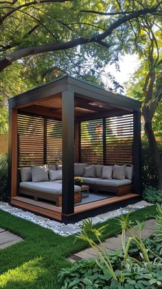 an outdoor living area with couches and trees in the background