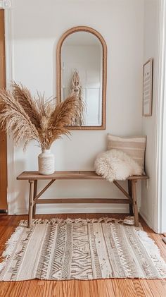 a wooden bench sitting in front of a mirror on top of a wall next to a rug