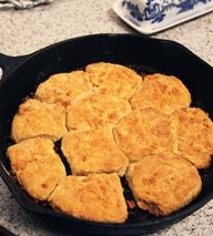 a skillet filled with biscuits sitting on top of a counter