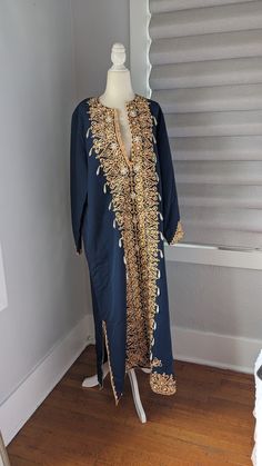 "Gorgeous Egyptian blue cotton women's formal kaftan dress Made in Egypt Embellished with peach colored trim, gold sequins, and faux pearls, all sewn on by hand. There is no size The dress measures 16\" across the top of the shoulders, 23\" sleeves, 23\" across flat between the armpits, 52\" long. Both slits on sides are 14\" long up from the hemline. It is in excellent condition and is truly a unique, handmade vintage item" Hand Embellished Gold Dresses For Eid, Gold Hand Embellished Dress For Eid, Bollywood Style Embellished Evening Kurta, Hand Embellished Maxi Dress For Festivals, Elegant Hand Embellished Kaftan For Festivals, Elegant Hand Embellished Dress For Festivals, Elegant Hand Embellished Festive Kaftan, Festive Hand Embellished Kaftan For Festivals, Gold Sequined Dresses For Eid