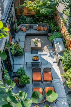 an aerial view of a patio with seating and trees in the backgrouund