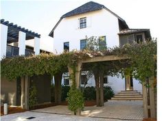 an image of a house with vines growing on the roof and in front of it