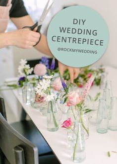 a person cutting flowers in vases on a table with the words diy wedding centerpiece