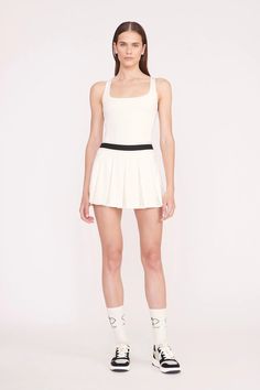 A pleated activewear mini skirt with elastic waistband and built-in shorts. The Double Skirt features moisture-wicking fabric technology to help you stay dry and comfortable on and off the court. Skirt With Elastic Waistband, Keds Champion, Custom Handbags, Fabric Technology, Novelty Bags, Work Looks, The Court, Well Dressed, Moisture Wicking Fabric