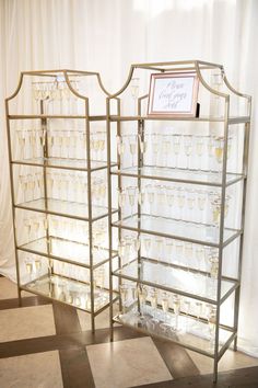 two glass display cases sitting on top of a checkered floor