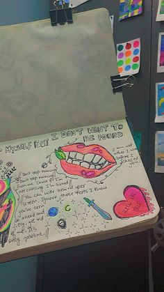 a drawing on a piece of paper in front of a refrigerator with magnets and stickers all over it