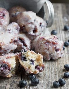 blueberry muffins are sitting on a wooden table