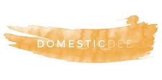 the word domestic written in white on an orange watercolor stain with brush strokees