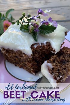 a piece of carrot cake with cream cheese frosting on a pink and white plate