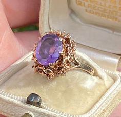 This is a fabulous and unique, 9ct Gold Brutalist design ring with a large oval Amethyst in the centre.  Brutalism was an offshoot of Modernism and originally applied to a type of raw, abstract and often angular architecture originating in the 1940s. The gold mounting on this ring is typically jagged and abstract in design and stands proud off the finger, giving the ring a feel of substance.  Size US 7.75, UK P The amethyst is prong set and measures 1.1cm x 9 mm. The head of the ring measures approximately 1.5 x 1.4cm and stands 8mm off the finger. Fully hallmarked for 9ct 375 gold, assayed in Birmingham in 1972/3 Lovely vintage condition Weight: 4.2g Comes gift-boxed, making a wonderful gift for, an anniversary or a birthday. Any boxes shown in the photos are for display only. Please stud Victorian Style Amethyst Ring Stamped 14k, Victorian Style 14k Stamped Amethyst Ring Gift, Antique Amethyst Ring In Yellow Gold For Gift, Victorian 14k Gold Amethyst Ring Collectible, Angular Architecture, Amethyst Ring Vintage, Brutalist Design, Antique Brooches, Purple Band