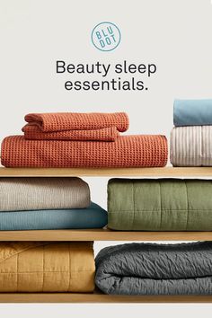 towels and blankets on shelves with the words beauty sleep essentials