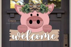 a welcome sign with a pig in the center and wreath on it's head