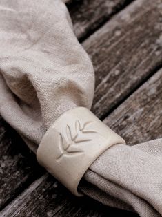 a napkin is wrapped around an object on a wooden surface