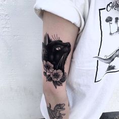 a person with a cat tattoo on their arm