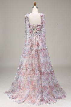 a white mannequin wearing a dress with pink and blue florals on it