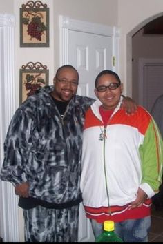 two men standing next to each other in front of a door