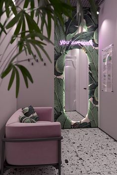 a pink chair sitting in front of a mirror next to a plant on the wall