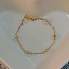 🌼 gold, dainty and beaded daisy bracelet. 🌼 ✧.* jewelry care tips: - keep away from water/moisture. - remove when sleeping. - avoid initial contact w/ perfume and lotion. - clean using a dry, soft cloth. ✧.* please note that after your package is shipped, i am not responsible for any damages/shipping issues that may occur. ✧.* i do not ship on weekends, which means your purchase will be shipped the following weekday. ✧.* thank you for shopping with me! please don't hesitate to contact me with Dainty Daisy Hypoallergenic Jewelry, Dainty Handmade Daisy Bracelets, Double Daisy Chain Bracelet, Summer Flower-shaped Gold Beaded Bracelets, Gold Heart-shaped Pearl Bracelet With Heart Beads, Adjustable Daisy-shaped Bracelet With Flower Charm, Daisy Bracelet, Daisy Necklace, Wedding Jewelry Bracelets