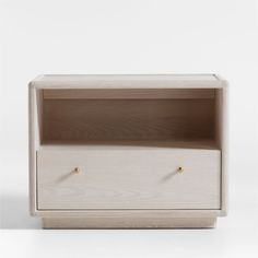 a white wooden shelf with two drawers on one side and an open drawer on the other