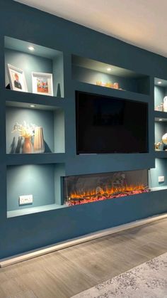 an entertainment center with built - in shelves and a fire place