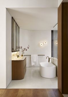 a bathroom with a large tub and two sinks on the opposite side of the room