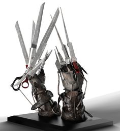 two pairs of sci - fi armor holding scissors on top of a black stand with white background