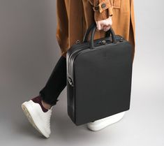 "This 10L bag is the perfect combination of style and function. Crafted from the finest leather, this bag features two main compartments, one with a zip closure and one with a magnetic closure for easy access. The timeless and minimalist design adds an extra level of sophistication to whatever outfit you wear. The adjustable shoulder strap ensures that it fits comfortably and securely on your body. The attention to detail put into this bag makes it a truly luxurious item. Each bag comes with its Tote Leather Bag, Bag Interior, Mac Book, Laptop Briefcase, Body Features, Laptop Tote, Laptop Rucksack, Sunglass Holder, Bag Luxury