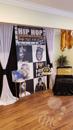 a stage set up for a hip hop event with gold balloons and black drapes