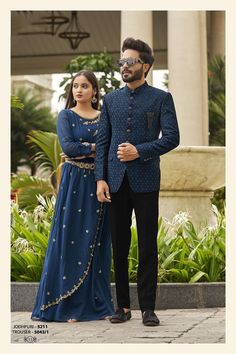 a man and woman dressed in blue standing next to each other