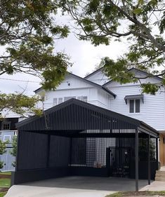 a large white house with a black fence around it