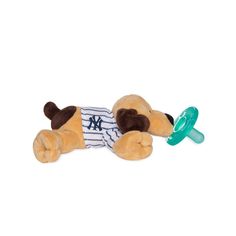 a stuffed dog laying down with a pacifier in its mouth