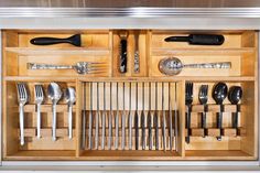 a drawer with utensils and spoons in it