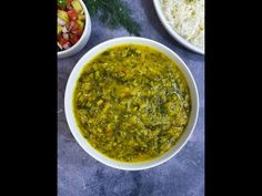 three bowls filled with different types of food on top of a blue table cloth next to rice and vegetables