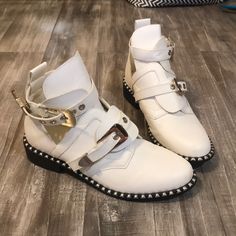 These Are Super Cool! Never Worn White Booties With Silver Buckles And Studs, Still Has Plastic Wrap Around Some Of The Buckles. White Round Toe Summer Boots, White Ankle-high Summer Boots, Trendy Flat Boots For Spring, Trendy White Closed Toe Boots, Chic White Boots With Flat Heel, Chic White Flat Heel Boots, White Booties, Plastic Wrap, Shoes White