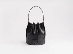 Our interpretation of a classic-- the bucket bag. Now, in a sweet and chic mini size. Utilitarian, minimal, still sophisticated and beautiful. In our beloved Buttero leather from Italy. Balloon shaped body for rich, soft pleats when the drawstrings are pulled tight. Roomy interior.Featuring a handle along with a detachable shoulder strap, easily making this a go-to everyday bag. Gold finish brass hardware. Lined interior. Made with the finest, full grain Italian vegetable tanned leather. This le Balloon Shapes, Drawstring Bucket Bag, Painting Edges, Everyday Bag, Vegetable Tanned Leather, Brass Hardware, Brown Gold, Gold Foil, Tan Leather