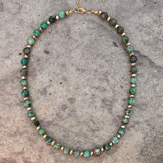 Discover the sophisticated elegance of African Turquoise with this beaded necklace, a perfect blend of traditional charm and contemporary style. This piece features an array of 8mm African Turquoise beads, known for their unique, earthy hues and intricate patterns. Alternating with the turquoise, 6mm gold-plated faceted spacers add a touch of luxury, making the necklace versatile for both casual and formal wear. 8mm African Turquoise 6mm gold-plated faceted spacers 18" necklace with a 3" extende Green Bohemian Necklace With 8mm Beads, Bohemian Turquoise Necklace With Spacer Beads, Bohemian Turquoise Necklace With Round Spacer Beads, Adjustable Green Turquoise Necklace With Spacer Beads, Bohemian Emerald Necklace With Round Beads, Turquoise Beaded Necklaces With 8mm Beads For Healing, Turquoise Beaded Necklace With 8mm Beads For Healing, Green Turquoise Necklace With Colorful Round Beads, Turquoise Chrysocolla Round Beads Necklace