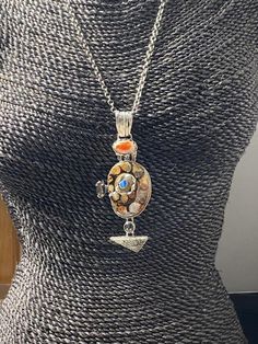 "Long Artisan Fossil with opals pendant Hand-made Sterling Silver 925. Stones used: Ammonite-fossil, Mexican Fire Opal, Pearl, Mystic Topaz, Fossil Coral, Australian Opal Height - 4\" (with bail), Width - 1 5/8\" Height -100mm (with bail), Width - 42mm Unique Handcrafted One-of a-kind Design Pendant Each Piece of Jewelry in my Collection is Absolutely One of a Kind! When you start wearing a piece of my jewelry you will fall in love with it more and more each day and feel that good Energy and Lov Silver Pendant Necklace With Inlay, Opal Pendant Necklace With Large Pendant, Opal Multi-stone Pendant Necklace, Silver Medallion Necklace With Natural Stones, Opal Cabochon Pendant Necklace, Silver Opal Fusion Jewelry, Artisan Silver Opal Necklace, Artisan Multi-stone Pendant Jewelry, Artisan Silver Opal Jewelry