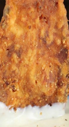 a piece of fried food sitting on top of a white plate