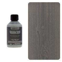 a bottle of wood glue next to a wooden panel